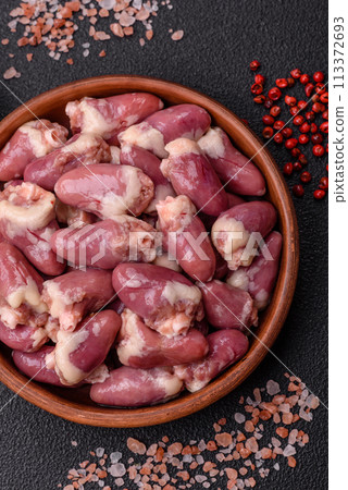 Raw chicken hearts with salt, spices and herbs Raw chicken hearts with salt, spices and herbs 113372693
