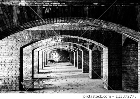 Endless brick passage with repeating archways in Fort Jefferson on Dry Tortugas National Park. Endless brick passage with repeating archways in Fort Jefferson on Dry Tortugas National Park. 113372773
