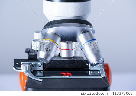 Blood sample on a glass slide under a microscope in the laboratory. Blood test research. Blood sample on a glass slide under a microscope in the laboratory. Blood test research. 113373005