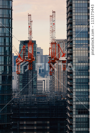 Tokyo cityscape: A view of the city where redevelopment construction is underway, seen between skyscrapers 113373443