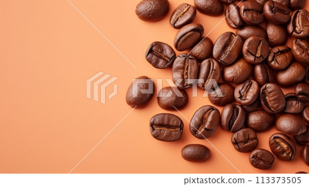 Coffee beans scattered on a peach background. Isolated on a solid color background. Coffee beans scattered on a peach background. Isolated on a solid color background. 113373505