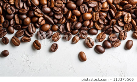 A pile of freshly roasted coffee beans on a white background, with organic beans scattered on a white table. A pile of freshly roasted coffee beans on a white background, with organic beans scattered on a white table. 113373506