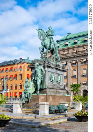 The statue of Gustav II Adolf is captured here standing proudly in Stockholm, Sweden, with clear skies and surrounded by the city architecture. The statue of Gustav II Adolf is captured here standing proudly in Stockholm, Sweden, with clear skies and surrounded by the city architecture. 113373609