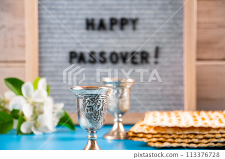 Happy Passover. Metal wine glasses and traditional Jewish matzo bread. 113376728