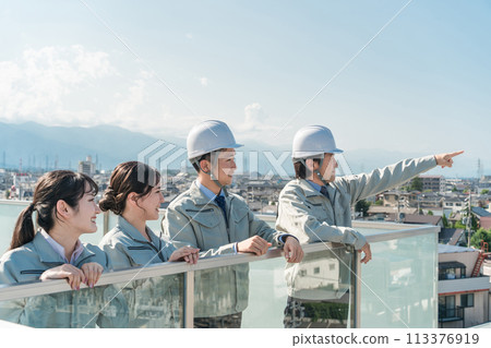 Male and female staff in the manufacturing, building, transportation, and construction industries wearing work clothes. 113376919