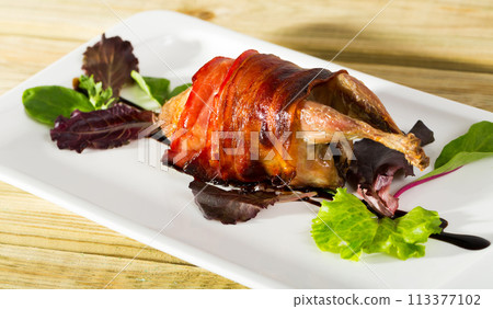 Baked in bacon quail with balsamic sauce is tasty dish Baked in bacon quail with balsamic sauce is tasty dish 113377102
