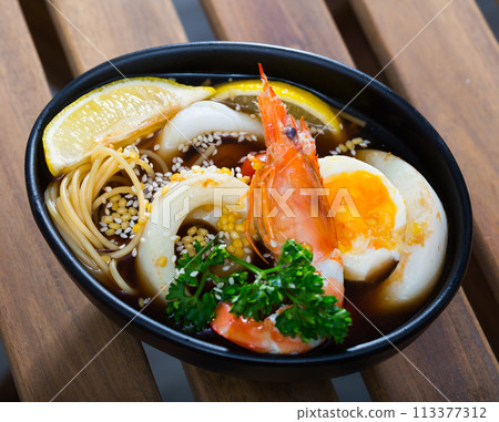 Bowl with spicy Pan-Asian soup 113377312
