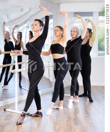 Girls in ballet class perform Batman with participation of mature female mentor Girls in ballet class perform Batman with participation of mature female mentor 113377619