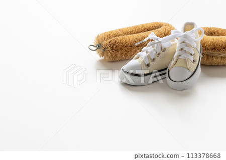 White sneakers and a scrubbing brush Shoe washing Image material for washing shoes 113378668