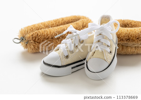 White sneakers and a scrubbing brush Shoe washing Image material for washing shoes 113378669
