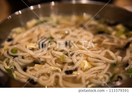 Kalguksu (noodle soup) made by kneading flour and cutting it with a knife to make noodles and boiling it with green onions and vegetables, a traditional Korean food 113379391