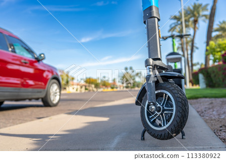 Selective focus on front wheel of a rental electric scooter in Phoenix, Arizona  113380922