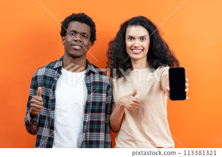 Happy Couple Showing Thumbs Up With Smartphone On Orange Background 113381321