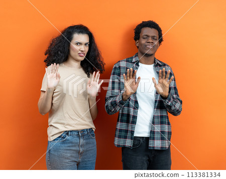 Reluctant Young Couple Refusing Offer With Hands Up 113381334