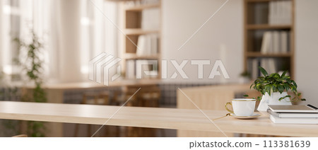 A space for displaying products on a wooden table in a beautiful minimalist library or bookstore. 113381639