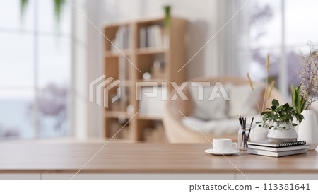 A wooden tabletop adorned set against a blurred background of a cozy Scandinavian living room. A wooden tabletop adorned set against a blurred background of a cozy Scandinavian living room. 113381641