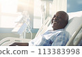 Male patient, elderly dark-skinned African American woman, in a modern, light-colored medical ward of a hospital with modern equipment, new technologies. 113383998