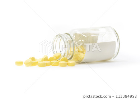 Yellow pills spilling out of the bottle Yellow pills spilling out of the bottle 113384958