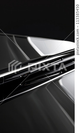 Close-up of a black smartphone's edge showing part of the display and buttons, with a reflection 113385450