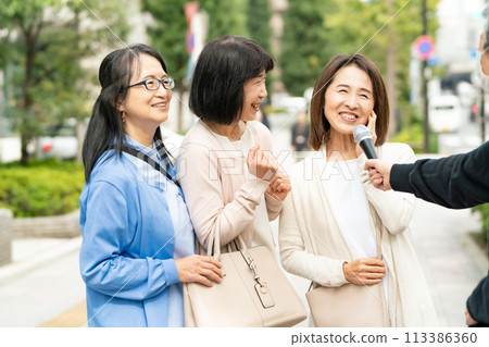 A woman responding to an interview on the street A woman responding to an interview on the street 113386360