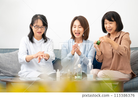 A woman in her 60s trying out cosmetics A woman in her 60s trying out cosmetics 113386376