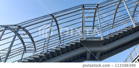 Modern steel pedestrian staircase with clear blue sky 113386390