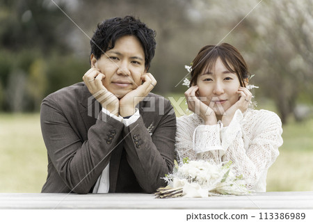 A casual wedding on a spring day with cherry blossoms in bloom A casual wedding on a spring day with cherry blossoms in bloom 113386989