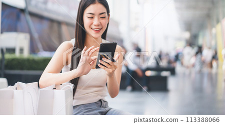 Focus on mobile phone woman using smartphone and credit card for shopping city lifestyles 113388066
