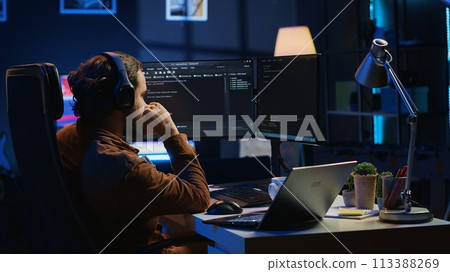 Frenzied programmer suffering from adhd illness, impatiently taping desk with fingers while writing code. Jittery IT expert doing multitasking in office, drinking coffee, listening music, camera A Frenzied programmer suffering from adhd illness, impatiently taping desk with fingers while writing code. Jittery IT expert doing multitasking in office, drinking coffee, listening music, camera A 113388269