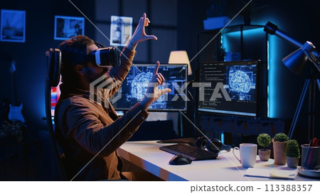 Computer scientist wearing VR glasses panicking after AI gains omniscience, throwing goggles and programming firewall. Programmer afraid by artificial intelligence gaining enlightenment, camera B 113388357