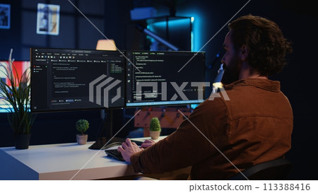 Developer arriving in apartment office with coffee mug in hand, ready to start coding on computer. IT specialist begins teleworking job shift, holding cup of tea, upgrading company software, camera B Developer arriving in apartment office with coffee mug in hand, ready to start coding on computer. IT specialist begins teleworking job shift, holding cup of tea, upgrading company software, camera B 113388416