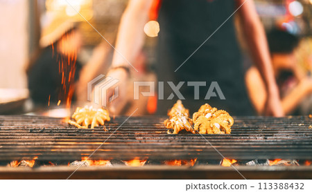 Thai style of grilled squid barbeque on fire charcoal Thai style of grilled squid barbeque on fire charcoal 113388432