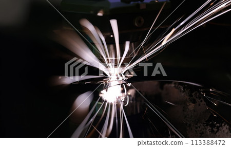 Hot sparks at grinding steel material closeup Hot sparks at grinding steel material closeup 113388472