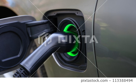 Electric car and charging at charging station closeup 113388494
