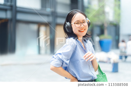 Young adult asian woman wear wireless headphone urban people lifestyles with positive self love Young adult asian woman wear wireless headphone urban people lifestyles with positive self love 113388508