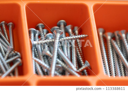 Collection of nails, screws and bolts in plastic box 113388611