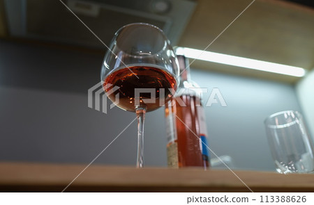 Closeup of glass goblet with rose wine bottom view Closeup of glass goblet with rose wine bottom view 113388626