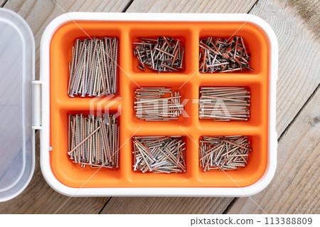 Collection of nails, screws and bolts in plastic box 113388809