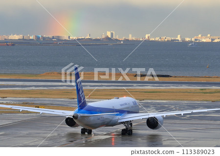 Passenger planes taking off and landing with a rainbow on the opposite shore in the background Passenger planes taking off and landing with a rainbow on the opposite shore in the background 113389023