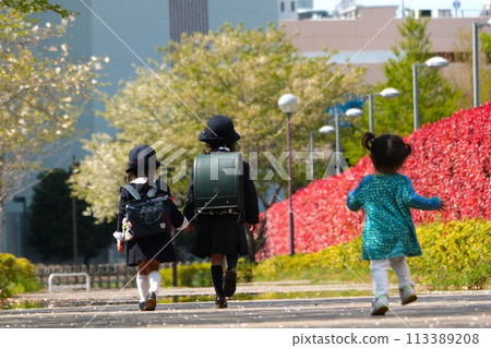 Toddler chasing his sister Toddler chasing his sister 113389208
