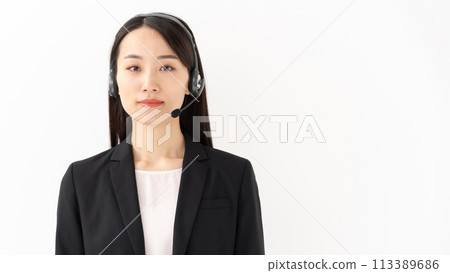Smiling operator woman in her 20s wearing a suit Smiling operator woman in her 20s wearing a suit 113389686
