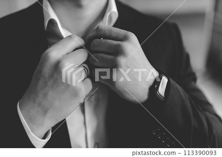 groom in a suit adjusts his shirt collar groom in a suit adjusts his shirt collar 113390093