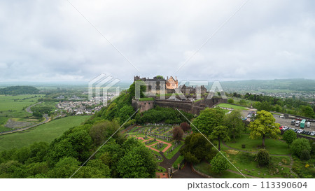 Aerial view of Stirling Castle above lush landscape, embracing the vast Scottish countryside 113390604