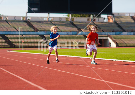 Child running in stadium. Kids run. Healthy sport. 113391012