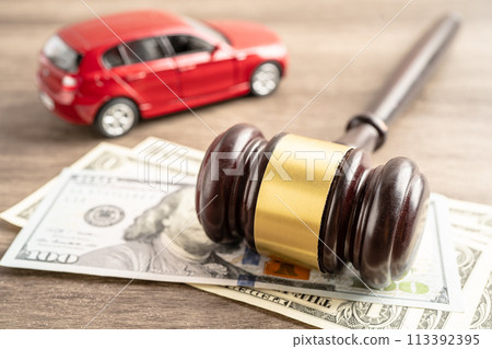 Hammer gavel judge and US dollar banknote money with car vehicle accident, insurance coverage claim lawsuit court case. Hammer gavel judge and US dollar banknote money with car vehicle accident, insurance coverage claim lawsuit court case. 113392395