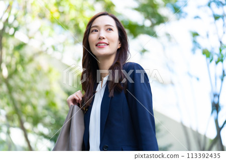 Looking up at a business woman Looking up at a business woman 113392435
