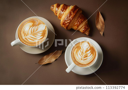 Creamy latte art. Two mugs of latte with croissants. Delicious and pleasant breakfast. 113392774