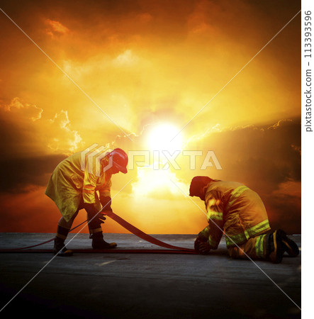 Firefighters are preparing their fire hoses to combat the blaze 113393596