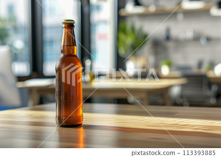 A bottle of beer sits on a wooden table in a room with a view of the outside 113393885