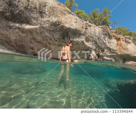 Woman on tropical vacation paradise on sea. Summer sea joy in Turkish seacoast, beaches along Lycian Way, Turkish Riviera. Asian female underwater and turquoise ocean around. 113394844